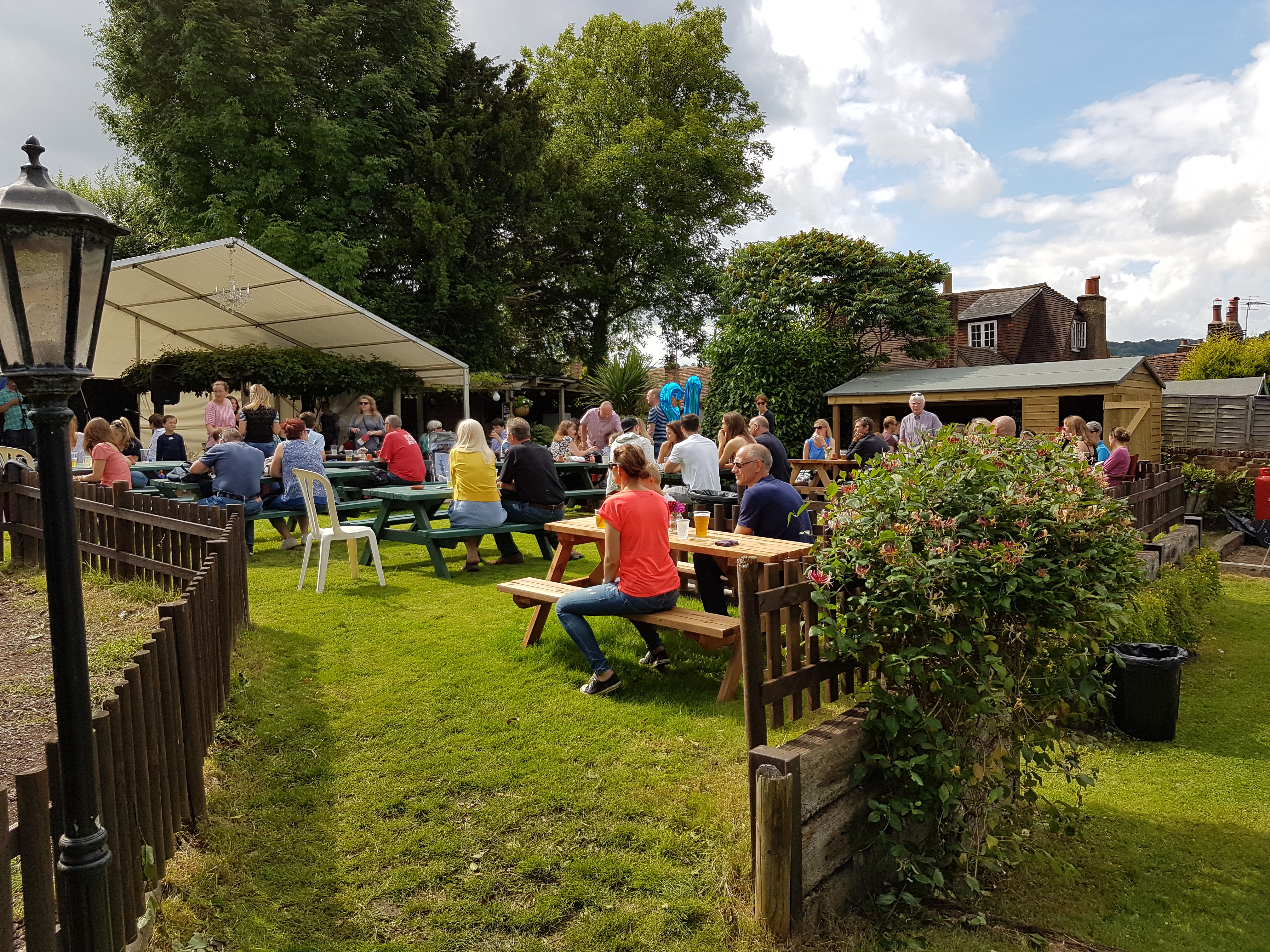 Families enjoying the busy beer garden in summer