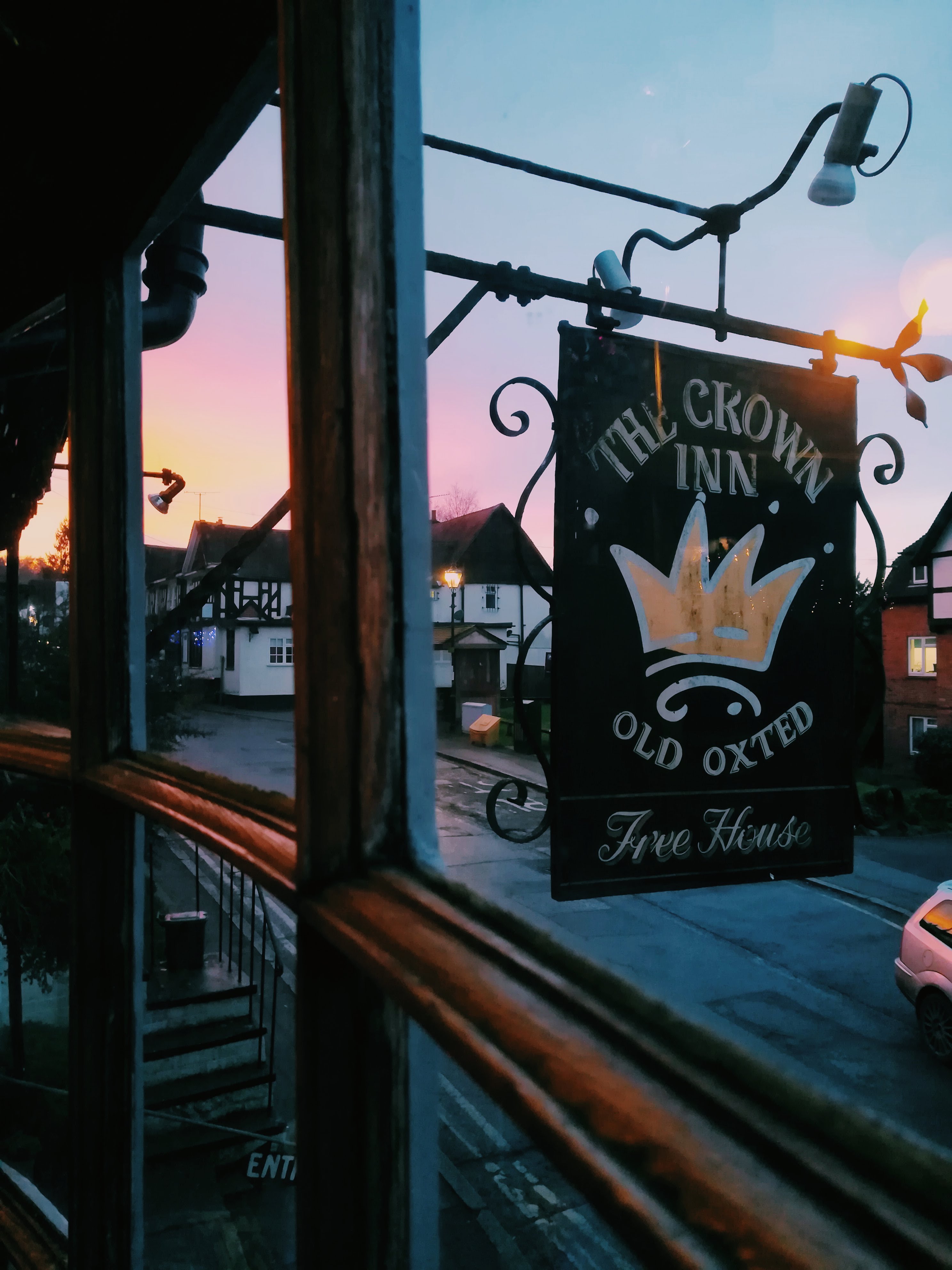 The Crown Inn pub sign at sunset on Old Oxted High Street